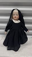 Full front view of doll standing in nun habit