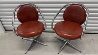 Pair of matching chrome swivel chairs front view