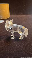 Left-front view of faceted crystal wolf figurine, box visible in background
