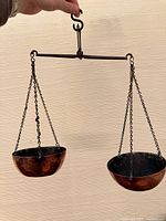 Full view of balance scale showing both copper bowls and wrought iron beam