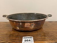 Side view showing hammered copper body and brass handles