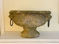 Front view of footed pottery jardiniere showing overall shape and patina