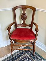 Full front view of antique walnut armchair