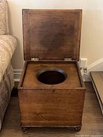 Commode open showing circular seat opening