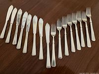 Full set of 8 fish knives and 8 forks laid out