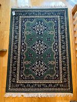 Full view of green Persian-style area rug