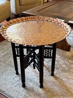 Copper tray on wooden folding base forming table