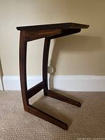 Left side view of C-shaped wood side table