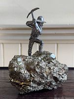 Front view of pewter miner figurine on pyrite cluster