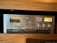 Front view of AKAI GXC-730D deck powered on inside cabinet
