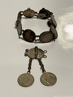 Bracelet and detached clasp with two coin dangles overview