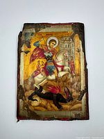 Front of icon showing Saint George slaying dragon with visible paint loss