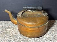 Right side view of copper kettle showing spout, handle and overall form