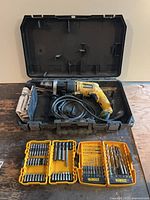 Drill in open case with bit sets displayed