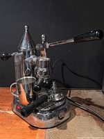 Full view of Gaggia Factory lever espresso machine with accessories in drip tray