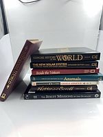 All eight books stacked showing spines