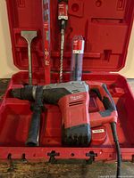 Rotary hammer, case and accessories displayed