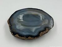 Top view of polished agate ashtray showing concentric banding and inner basin