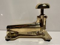 Left side view of gold tone El Casco stapler