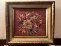 Full view of framed floral needlepoint