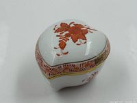 Heart-shaped trinket box front side view showing floral design and gold rim