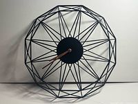 Front view showing full geometric frame and hands