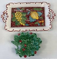 Top view of both ceramic items: Italian fruit platter and Portuguese strawberry dish