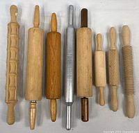 All eight rolling pins laid out side by side