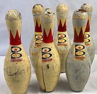 Front group view of six Brunswick Score King pins showing overall condition