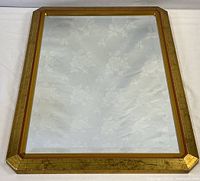 Full view of rectangular gold framed mirror