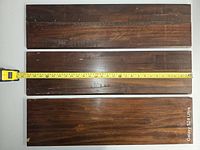 Three dark wood shelves with tape measure showing ~31 inch length