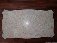 Top view of entire marble slab showing color, veining and shaped edges