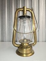 Front view of brass Dietz kerosene lantern