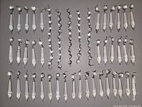 All crystal drops and bead strands laid out on dark surface