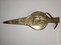 Full view of bellows front showing brass tall-ship embossing