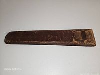 Full view of worn brown leather slide rule case