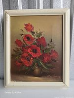 Front view of framed oil painting showing red poppies bouquet and signature