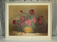 Front view of framed oil painting showing red roses composition and signature
