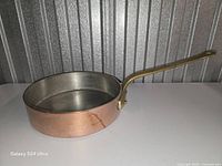 Side view showing copper body and brass handle