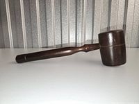 Full side view of dark wooden gavel