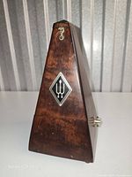 Front view showing walnut case, Wittner logo badge