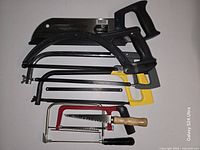 All seven saws arranged flat showing variety and condition