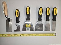 All six Richard brand tools laid out with tape measure for scale