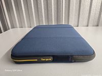 Sleeve angled showing front panel, zipper, logo