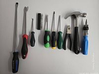 Full set of 11 hand tools laid out side by side