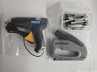 Group view of glue gun, staple gun and staples