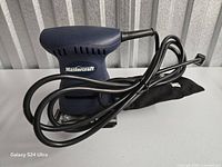 Mastercraft palm sander front view with cord and dust bag