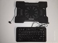 Top view of Cooler Master cooling pad and USB keyboard showing overall condition