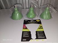 Three green Feith Electric LED grow bulbs with packaging card.
