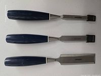 Three Mastercraft chisels with guards attached
